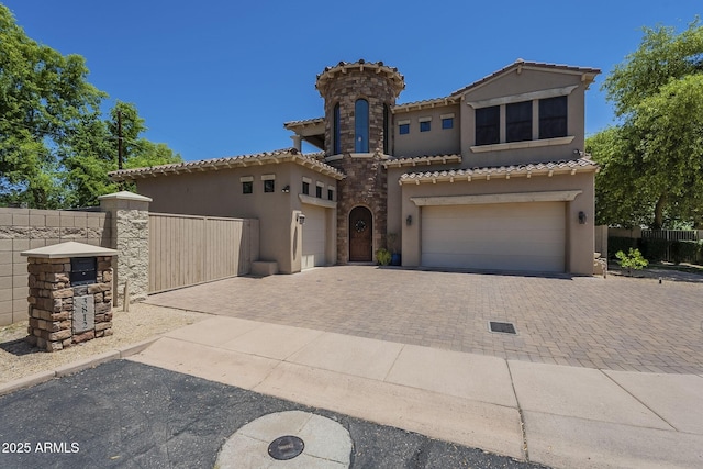 3812 E Camelback Rd, Phoenix, AZ 85018 - mediterranean / spanish house featuring stucco siding, decorative driveway, a tile roof, and an attached garage
