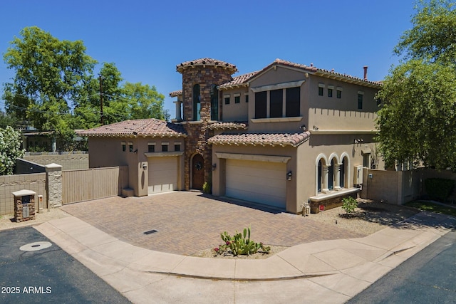 3812 E Camelback Rd, Phoenix, AZ 85018 - mediterranean / spanish house with stucco siding, decorative driveway, a tile roof, and a gate