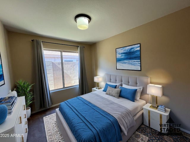 bedroom with baseboards and carpet