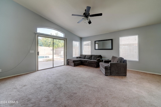 carpeted living room with high vaulted ceiling and ceiling fan