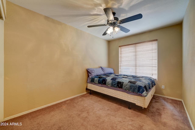 carpeted bedroom featuring baseboards and a ceiling fan