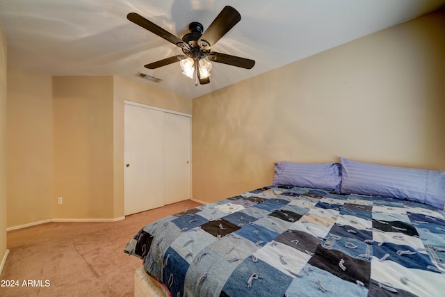 bedroom featuring ceiling fan, a closet, and carpet floors