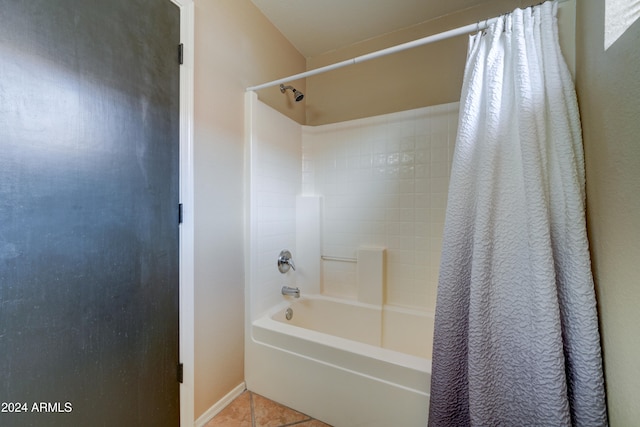 bathroom with tile patterned flooring and shower / bath combo