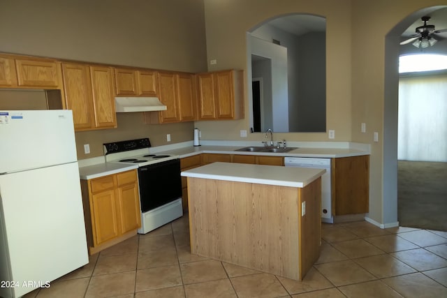 kitchen with white appliances, a center island, ceiling fan, light tile patterned flooring, and sink