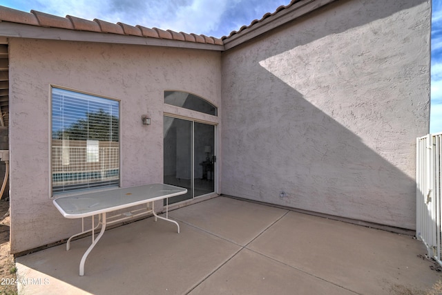 rear view of house with a patio and stucco siding