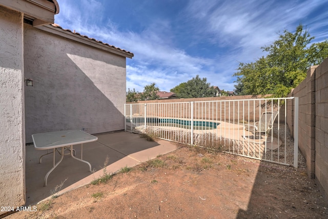 view of yard featuring a patio area, a fenced in pool, and a fenced backyard
