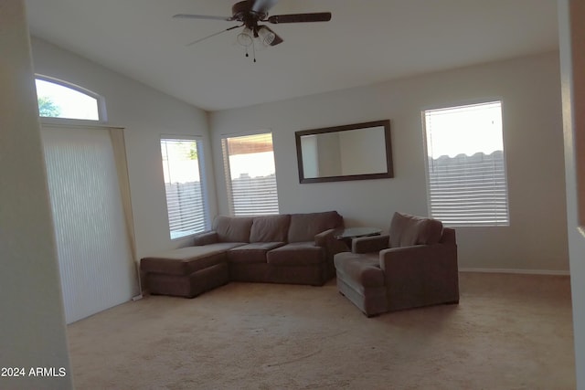 carpeted living room with ceiling fan and lofted ceiling