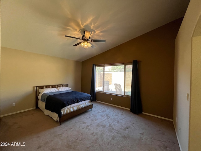 bedroom featuring ceiling fan, vaulted ceiling, and light carpet