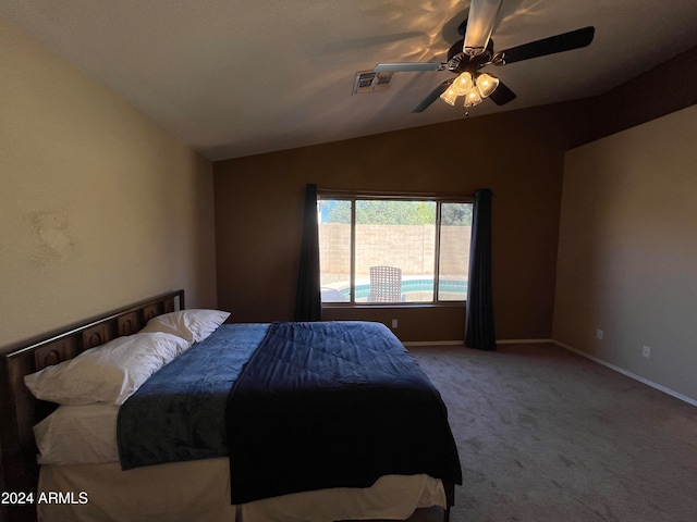 carpeted bedroom featuring lofted ceiling and ceiling fan