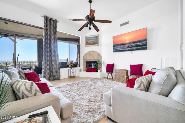 3335 W Carriage Dr, Phoenix, AZ 85086 - living area with a fireplace, tile patterned flooring, visible vents, and ceiling fan