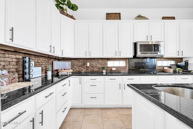3335 W Carriage Dr, Phoenix, AZ 85086 - kitchen featuring decorative backsplash, stainless steel microwave, and white cabinets