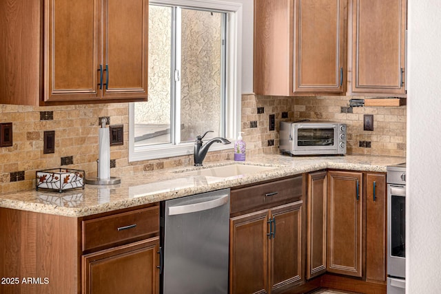 14819 W Lupine Ln, Surprise, AZ 85374 - kitchen with stainless steel appliances, a sink, decorative backsplash, light stone countertops, and brown cabinetry