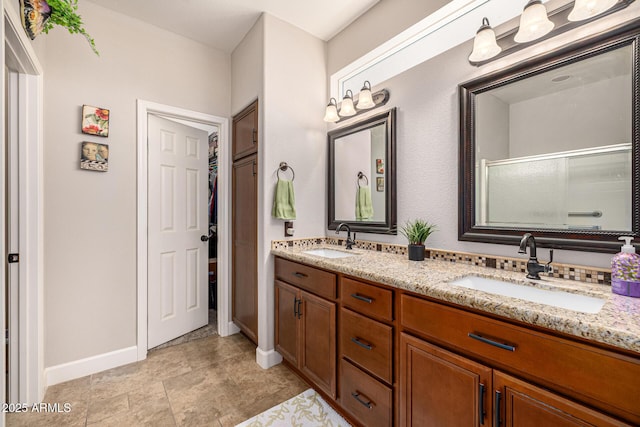 14819 W Lupine Ln, Surprise, AZ 85374 - full bathroom with double vanity, baseboards, and an enclosed shower