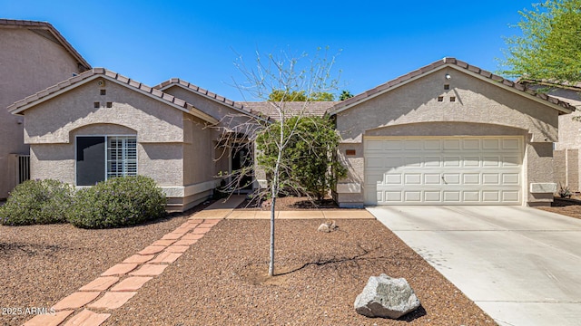 14819 W Lupine Ln, Surprise, AZ 85374 - view of front of home featuring concrete driveway, stucco siding, an attached garage, and a tiled roof