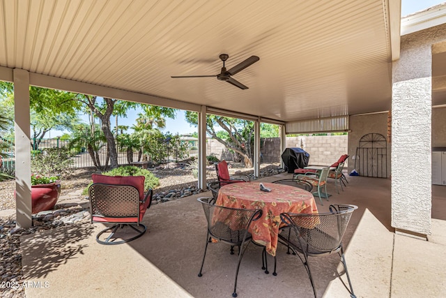 14819 W Lupine Ln, Surprise, AZ 85374 - fenced backyard with a patio, grilling area, ceiling fan, and outdoor dining space