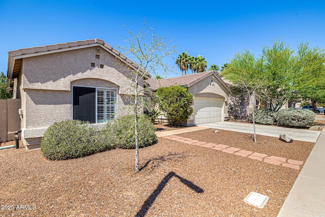 14819 W Lupine Ln, Surprise, AZ 85374 - view of front of home with stucco siding, driveway, a tiled roof, and an attached garage