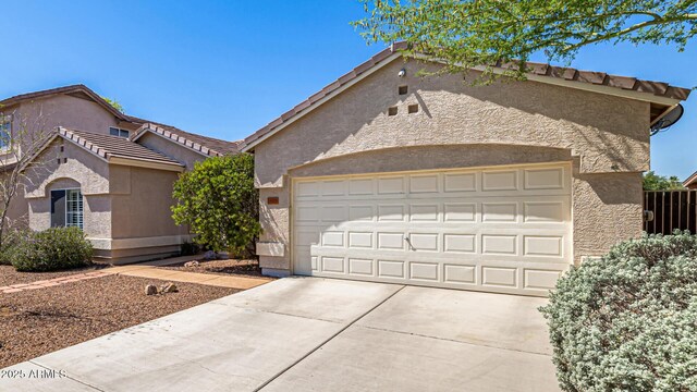 14819 W Lupine Ln, Surprise, AZ 85374 - view of front of home featuring concrete driveway, stucco siding, a tiled roof, and a garage