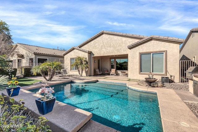 view of pool featuring a patio area and a grill