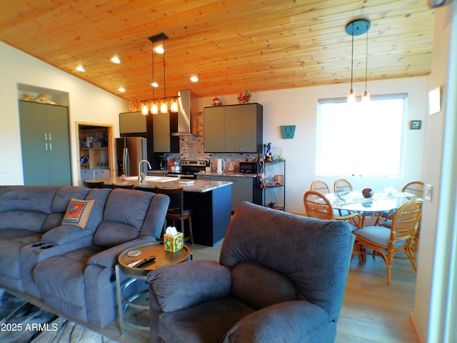 living room with lofted ceiling, light wood finished floors, wood ceiling, and recessed lighting