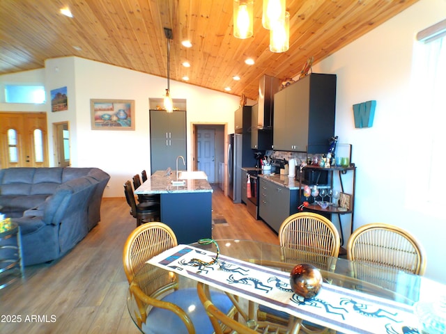 dining room featuring wooden ceiling, vaulted ceiling, light wood-style floors, and recessed lighting