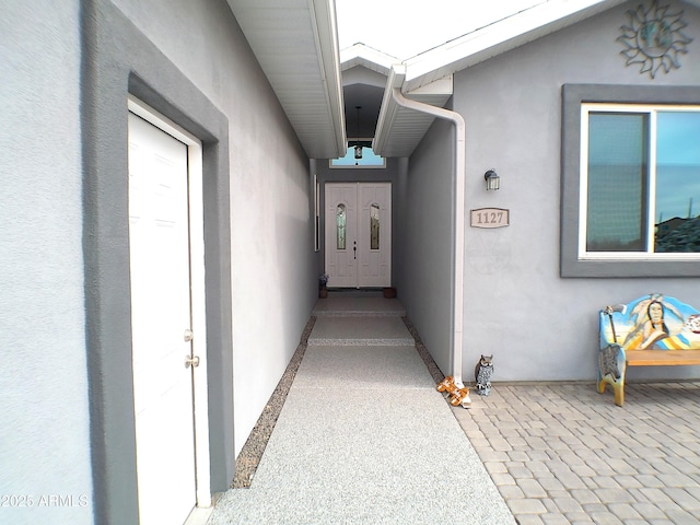 entrance to property featuring stucco siding