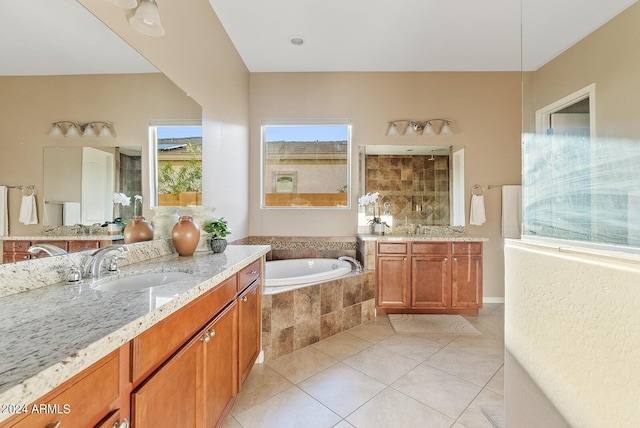 bathroom with tile patterned flooring, vanity, and separate shower and tub