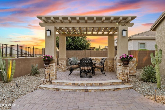 patio terrace at dusk featuring a pergola