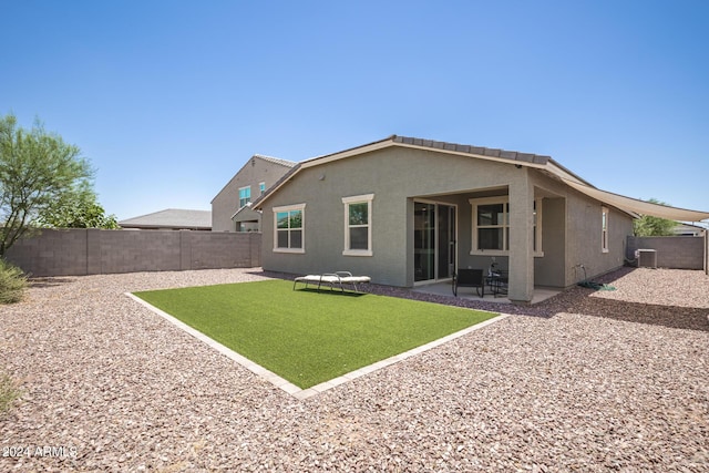 rear view of property with stucco siding and a patio