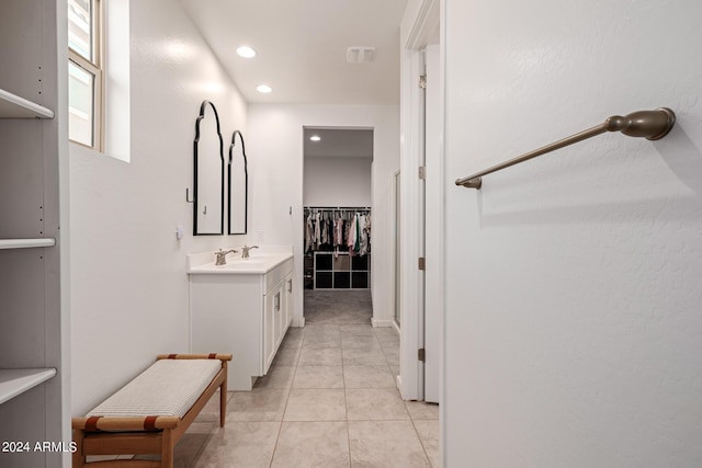 bathroom with vanity, tile patterned flooring, recessed lighting, and a walk in closet