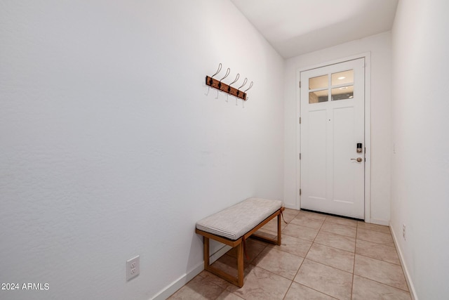 entryway featuring light tile patterned floors and baseboards