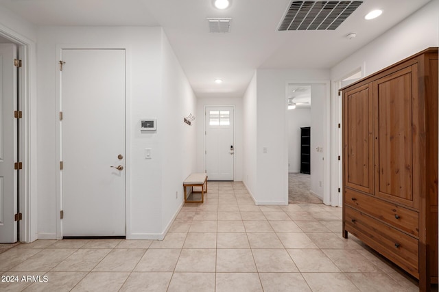 entrance foyer with recessed lighting, baseboards, and light tile patterned floors