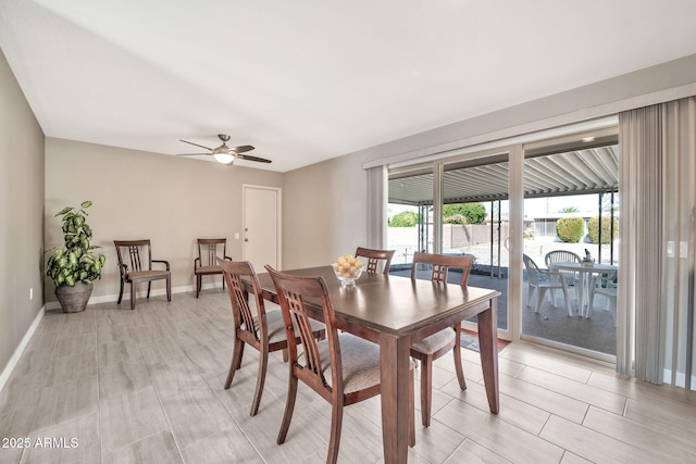 dining area featuring a ceiling fan and baseboards