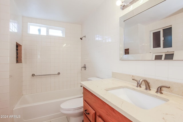 6219 S 12th Pl, Phoenix, AZ 85042 - bathroom featuring vanity, washtub / shower combination, and tile walls