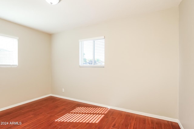 6219 S 12th Pl, Phoenix, AZ 85042 - unfurnished room featuring baseboards and wood finished floors