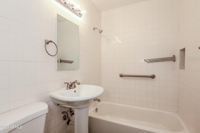 6219 S 12th Pl, Phoenix, AZ 85042 - bathroom featuring tile walls, bathing tub / shower combination, and tasteful backsplash