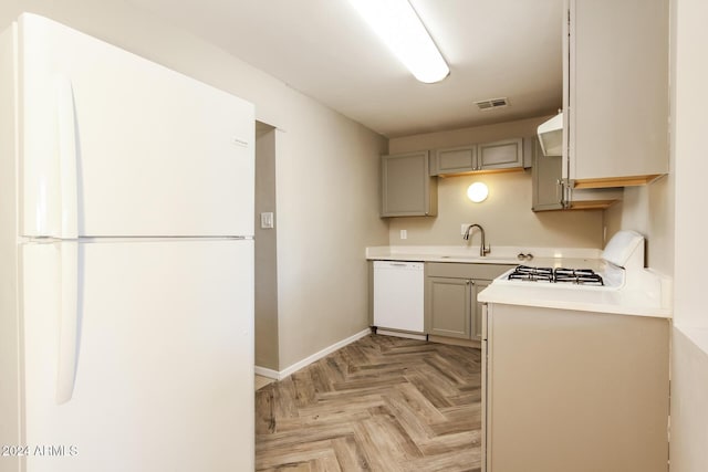 6219 S 12th Pl, Phoenix, AZ 85042 - kitchen with white appliances, gray cabinets, light countertops, and range hood