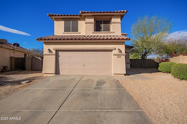 mediterranean / spanish-style home featuring stucco siding, concrete driveway, an attached garage, a gate, and fence