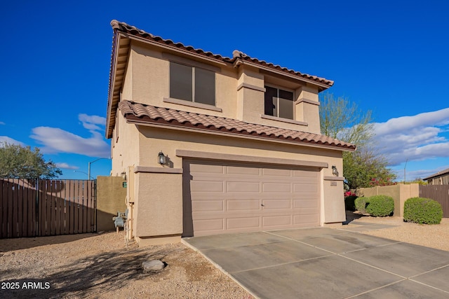 mediterranean / spanish-style house featuring a garage, driveway, fence, and stucco siding