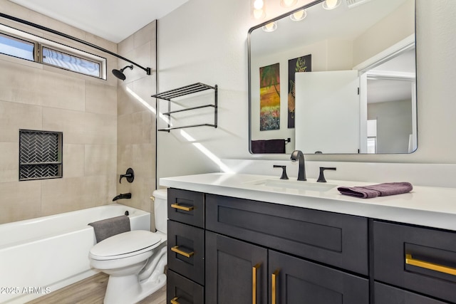 full bathroom featuring toilet, shower / bath combination, wood finished floors, and vanity