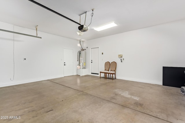 garage featuring a garage door opener, water heater, and baseboards