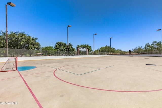 view of basketball court featuring fence