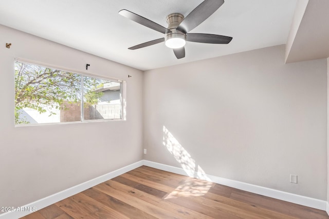 empty room featuring hardwood / wood-style floors and ceiling fan