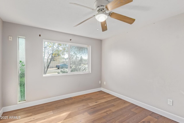 unfurnished room with ceiling fan and wood-type flooring