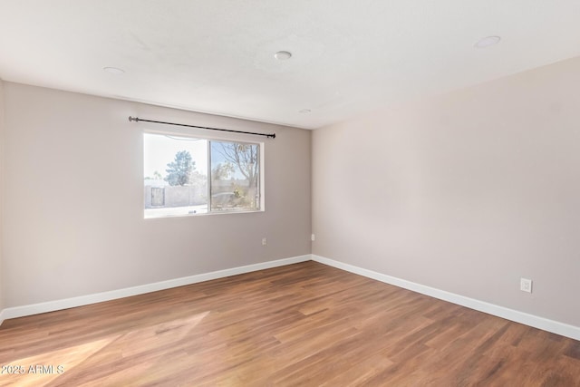 unfurnished room featuring hardwood / wood-style flooring