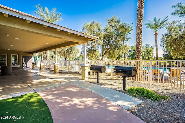 view of property's community featuring a patio area and a pool