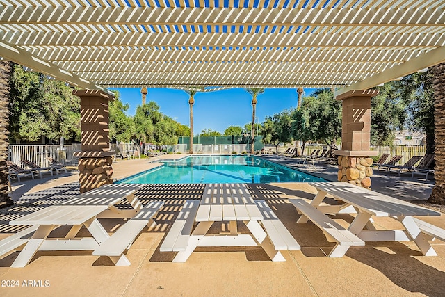 view of swimming pool with a patio and a pergola