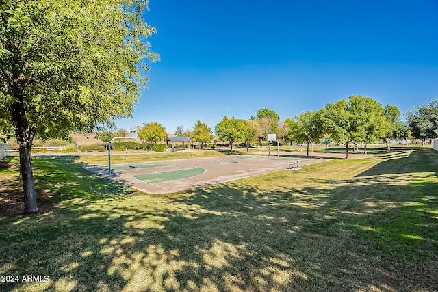 view of sport court featuring a lawn