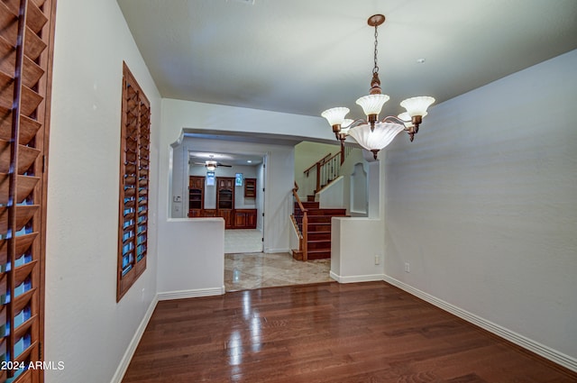 interior space featuring hardwood / wood-style floors and an inviting chandelier