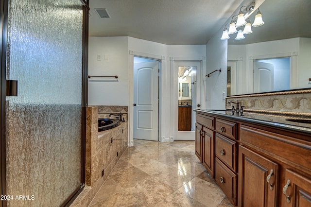 bathroom featuring vanity, a relaxing tiled bath, and tile flooring