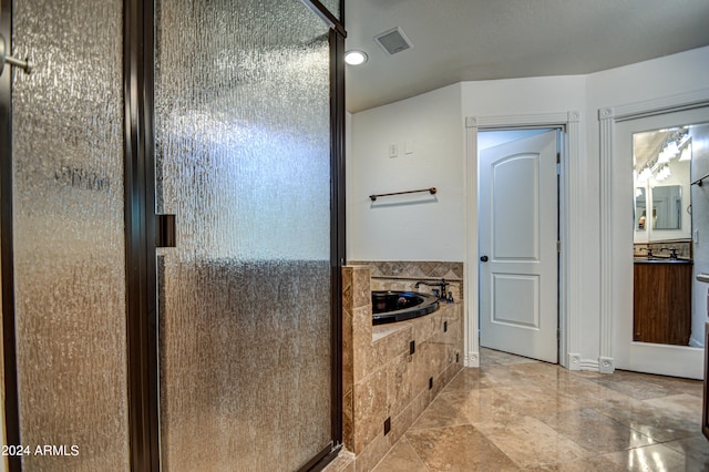 bathroom featuring tile flooring, vanity, and shower with separate bathtub